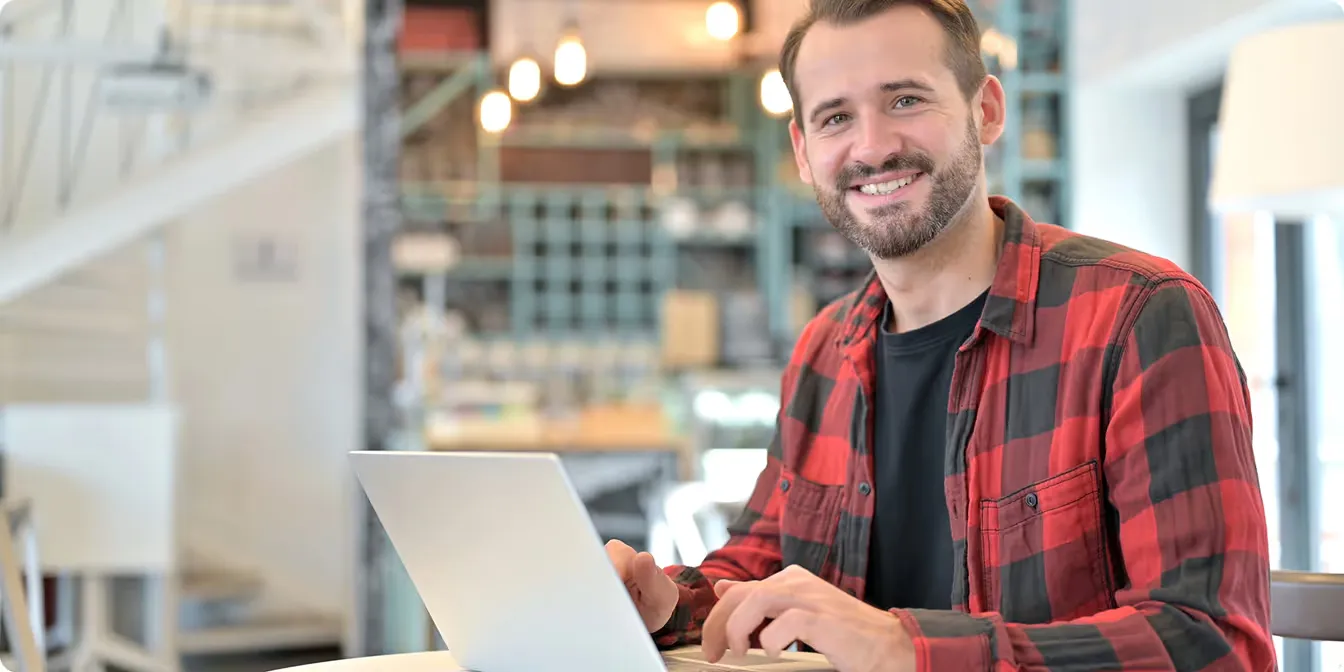 Smiling business owner working on a laptop
