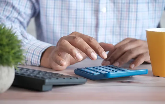 Working through personal finances with a calculator